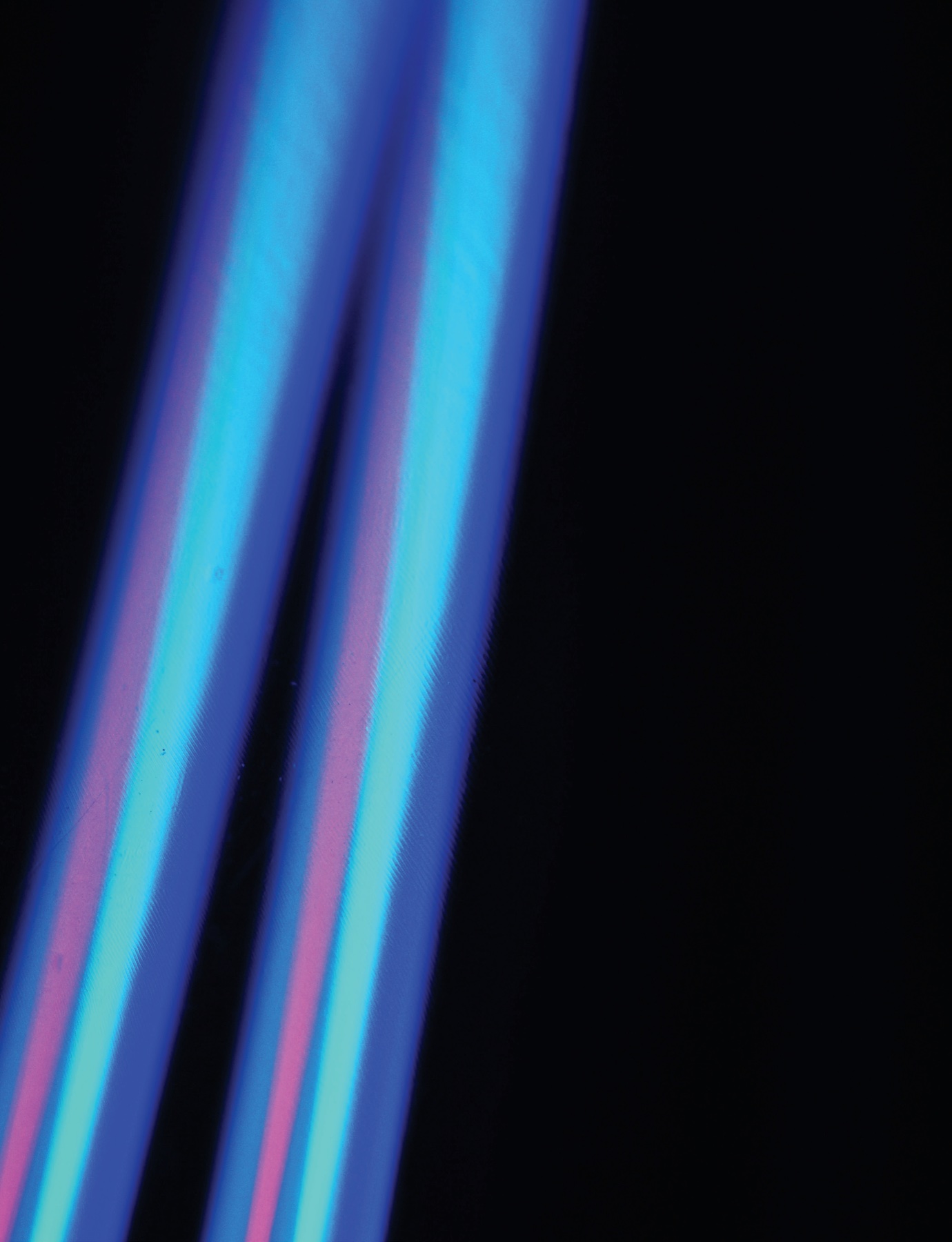 Streaks of blue and pink light on black