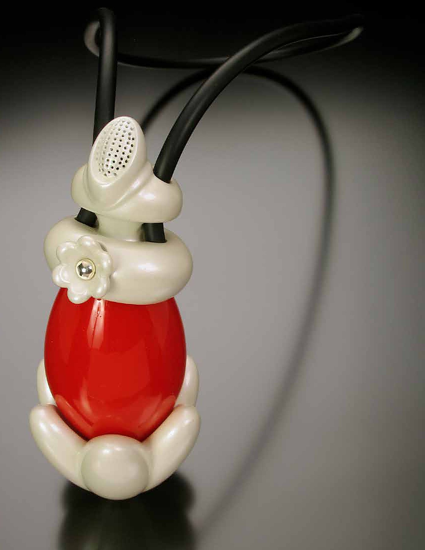 Red and white pendant on black cords