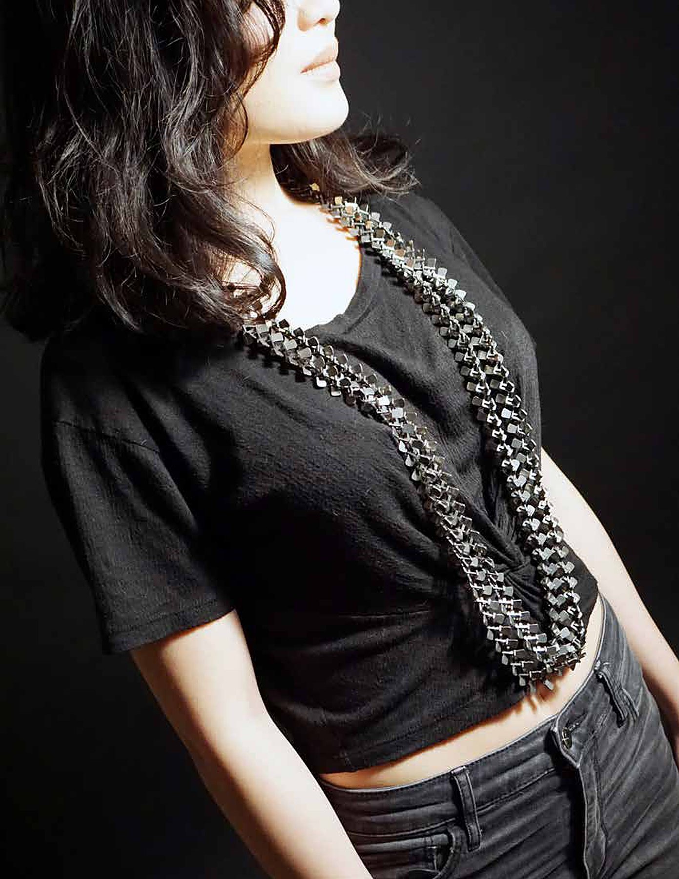 Woman in a black shirt and chain necklace